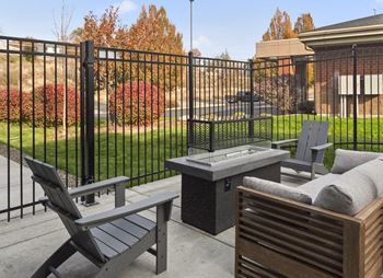 Outdoor lounge with pergola, gas grills, and fire pit