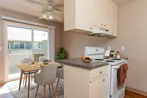 Beaverton apartment for rent - a kitchen with a table and chairs and a stove