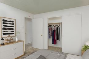 Corvallis apartment for rent - a bedroom with a closet and a bed and a dresser with clothes hanging on