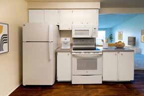 Portland apartment for rent - a kitchen with white cabinets and appliances and a white refrigerator