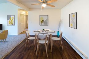 Portland apartment for rent - a dining room with a table and chairs and a ceiling fan