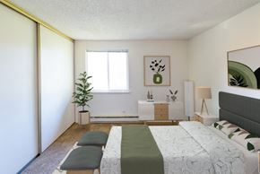 Portland apartment for rent - a bedroom with a bed and a dresser and a window