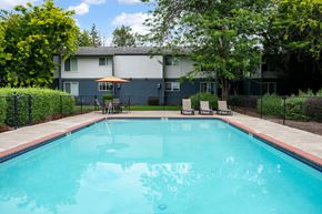 Salem apartment for rent - A swimming pool surrounded by a fence and trees.