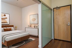 Portland apartment for rent - A bedroom with a bed, nightstand, and artwork.