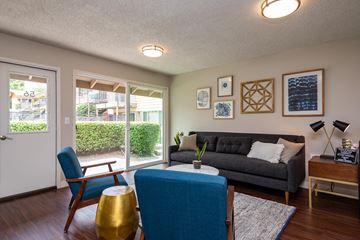 Portland apartment for rent - a living room with a couch and chairs and a sliding glass door