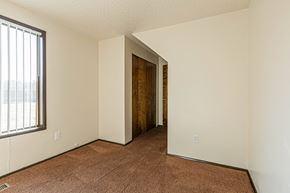 Albany apartment for rent - A room with a brown carpet and a brown door.