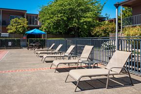 Portland apartment for rent - Pool deck showing lounge chairs with tables.