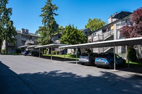 Tigard apartment for rent - a row of apartment buildings with cars parked in front of them