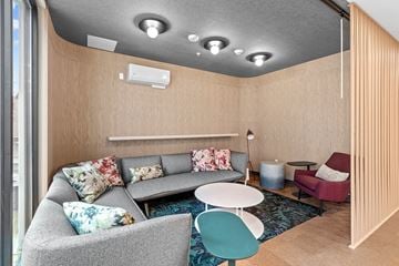 Spokane apartment for rent - A living room with a grey couch and a blue chair.