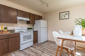 Kennewick apartment for rent - Model Kitchen with wood cabinetry and white appliances