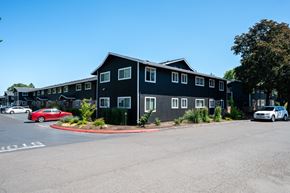 Beaverton apartment for rent - A black building with a parking lot in front of it.