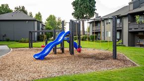 Hillsboro apartment for rent - a playground with a blue slide and monkey bars
