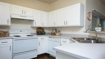 Village at main street | spacious kitchen with white cabinetry and appliances