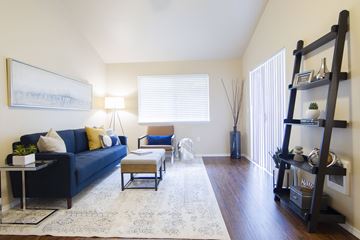 Corvallis apartment for rent - A living room with a blue couch, a coffee table, and a painting on the wall.