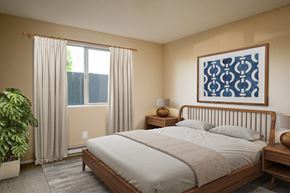 Corvallis apartment for rent - a bedroom with a bed and a window with white curtains