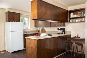 Corvallis apartment for rent - a kitchen with wooden cabinets and a white refrigerator