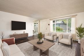 Salem apartment for rent - A living room with a flat screen TV mounted on the wall.