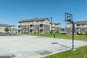 Boardman apartment for rent - an empty basketball court with an apartment building in the background