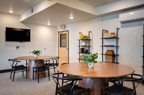 Everett apartment for rent - a dining room with tables and chairs and a tv on the wall
