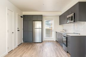 Bend apartment for rent - A kitchen with a refrigerator, oven, and microwave.