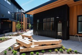 Bend apartment for rent - A modern building with a black exterior and wooden accents.