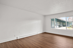 Hillsboro apartment for rent - an empty living room with wood floors and a large window