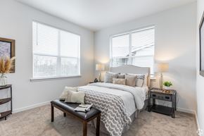 Albany apartment for rent - A bedroom with a large bed and a nightstand with a lamp.