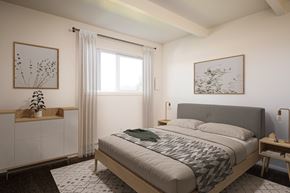 Portland apartment for rent - A bedroom with a large bed and a window with curtains.
