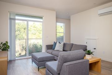 Ridgefield townhouse for rent - A living room with a grey couch and a wooden coffee table.