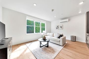 Portland apartment for rent - A living room with a white couch and a coffee table.