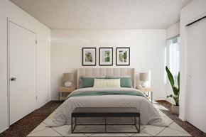 Tigard apartment for rent - a bedroom with white walls and a bed with green pillows
