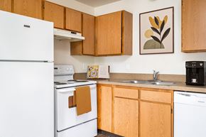 Salem apartment for rent - a kitchen with white appliances and wooden cabinets