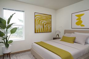 Salem apartment for rent - a bedroom with a white bed and a yellow blanket