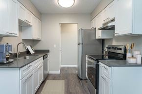 Portland apartment for rent - a kitchen with white cabinets and a stainless steel refrigerator