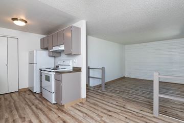Pasco apartment for rent - a kitchen with a stove and refrigerator in a room with a wooden floor