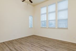Vancouver apartment for rent - Living Room with three large windows and a ceiling fan.