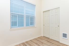 Vancouver apartment for rent - Bedroom with large window and double door closet.