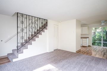 Portland apartment for rent - a living room with a staircase and a carpet floor