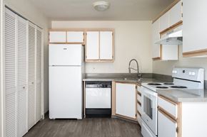 Tigard apartment for rent - a kitchen with white appliances and white cabinets