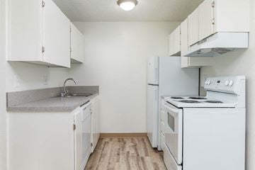 Pasco apartment for rent - a kitchen with white appliances and white cabinets