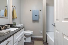 Portland apartment for rent - a bathroom with a toilet and a sink and a bath tub