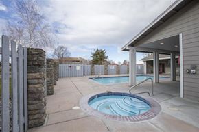 Kennewick apartment for rent - a swimming pool and a house with a fence