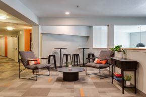 Corvallis apartment for rent - A modern lounge area with grey chairs and a round table.