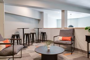 Corvallis apartment for rent - A modern living room with a grey sofa, a black coffee table, and a grey armchair.