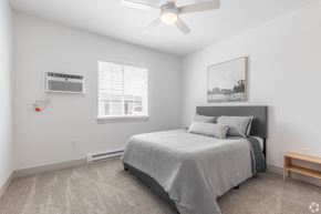 Boardman townhouse for rent - a bedroom with a bed and a ceiling fan