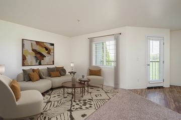 Battle Ground apartment for rent - A living room with a white couch, a coffee table, and a painting on the wall.