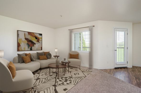 Battle Ground apartment for rent - A living room with a white couch, a coffee table, and a painting on the wall.