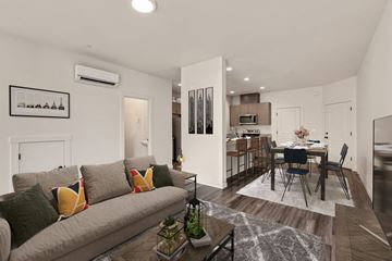 Ridgefield townhouse for rent - A modern living room with a grey couch and a coffee table.