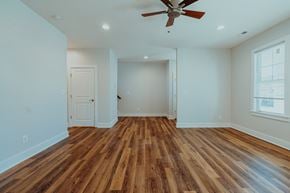Charlottesville townhouse for rent - A room with wooden floors and a ceiling fan.