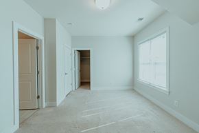 Charlottesville townhouse for rent - A spacious room with a carpeted floor and a large window.